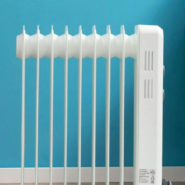 White oil-filled radiator heater with tall 9 fin array and side vent slits.