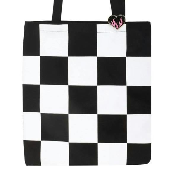 Black and white checkerboard tote bag front with flaming heart enamel pin badge