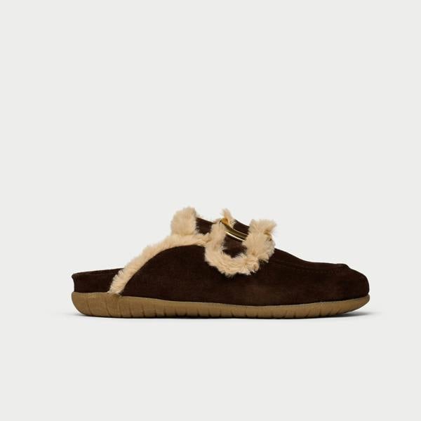 Brown slipper with beige fur trim on a white background