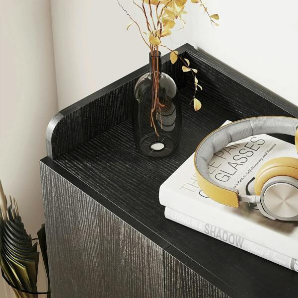 Black shoe cabinet top shelf with textured finish, showing stored items and shoes