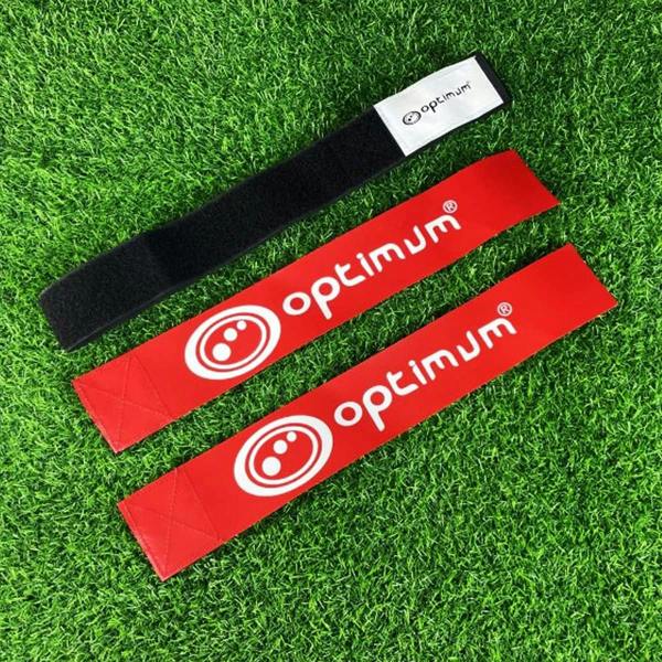 Black Optimum tag rugby belt with velcro tab and two red flags with white logo, on grass