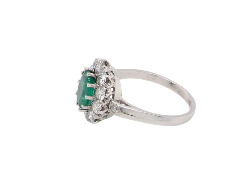 An Emerald and Diamond cluster ring side view