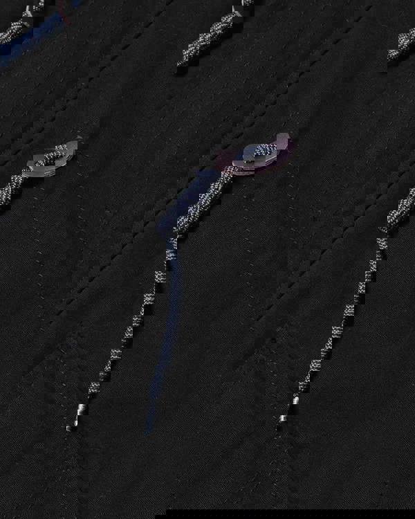 Lambretta Mens/Womens Carnaby Scooter Hooded Classic Mod Ska Badge Parka, close-up of the black parka showing the detailed drawstring and zipper pocket.