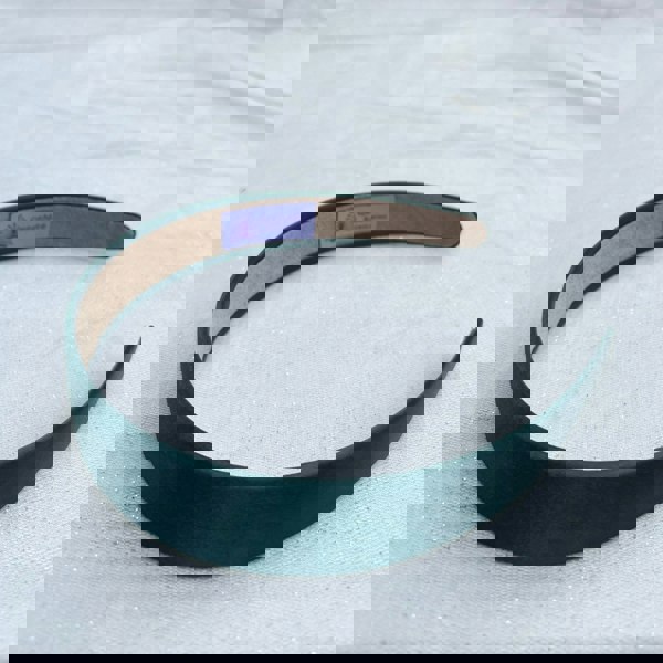 Dark green hairband, smooth satin finish, padded structure, rich deep green colour, minimalist classic design, versatile everyday accessory

