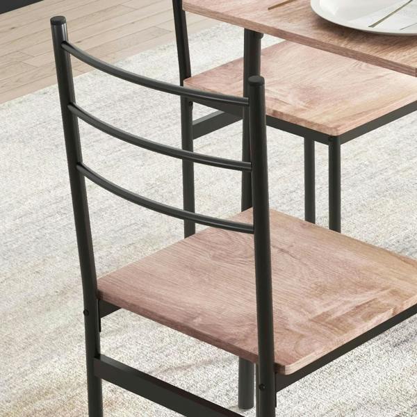 Black steel dining chair frame with curved back and wood-look seat; close-up