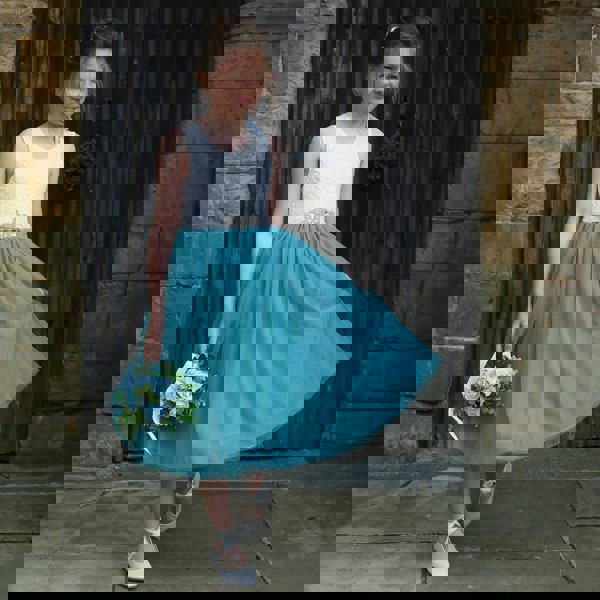 young girl holding flowers in church doorway