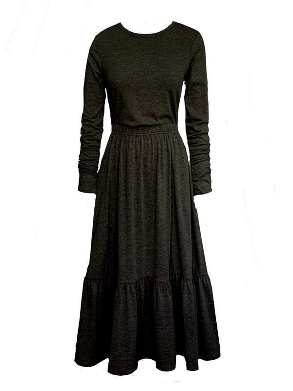 This is a boho gathered midi skirt with pockets in black, paired with a black long sleeve t-shirt with ruched elbows, silhouetted against a white background. 