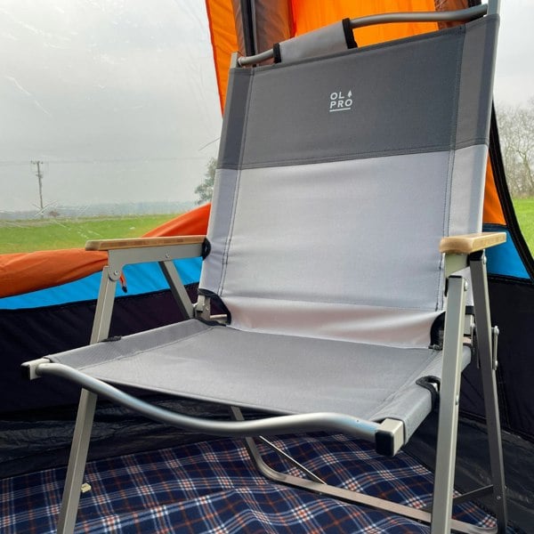 An image of the Ultralight Folding Chair from OLPRO placed inside of a camper van awning.