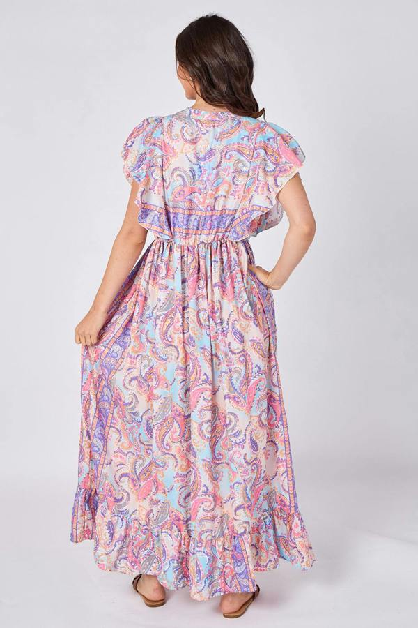 Woman wearing a colorful paisley dress on a white background