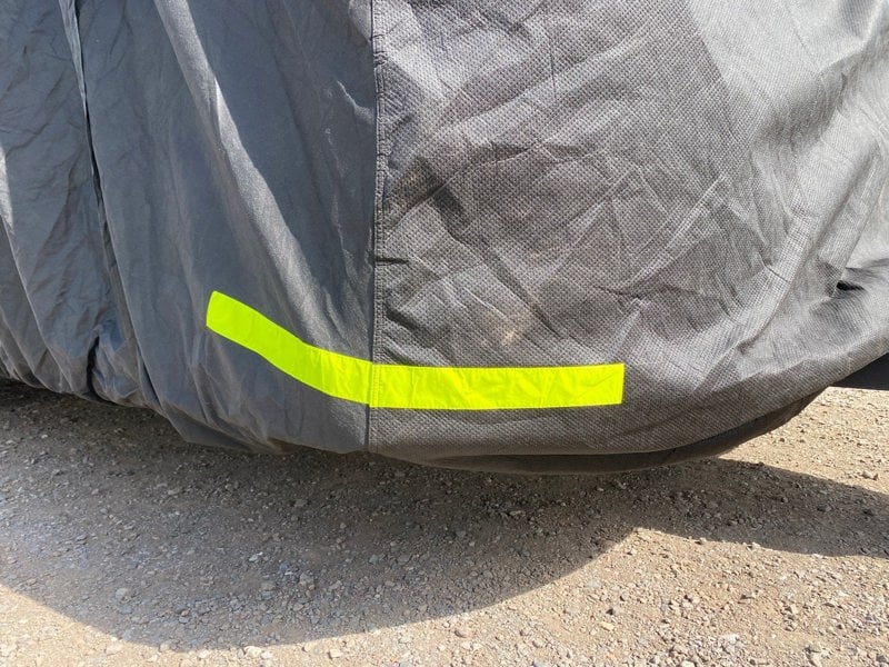 An image of the reflective strap on the back of the Breathable Waterproof 4Ply Caravan Cover with Free Hitch Cover Black from OLPRO.