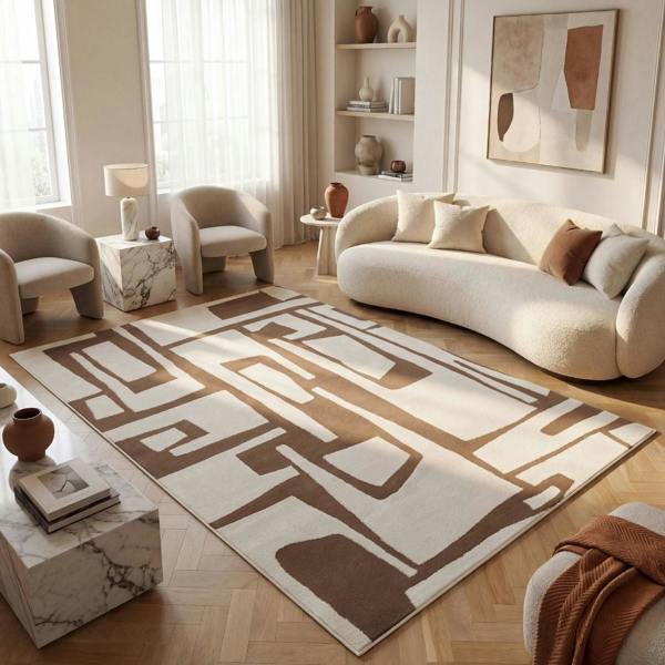 Modern living room with a patterned rug, sofa, and armchairs.