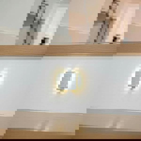 silver interior stair light mounted in the white riser of a staircase