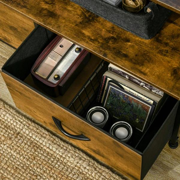 Open drawer compartment with books, cables, and photos inside rustic brown cabinet