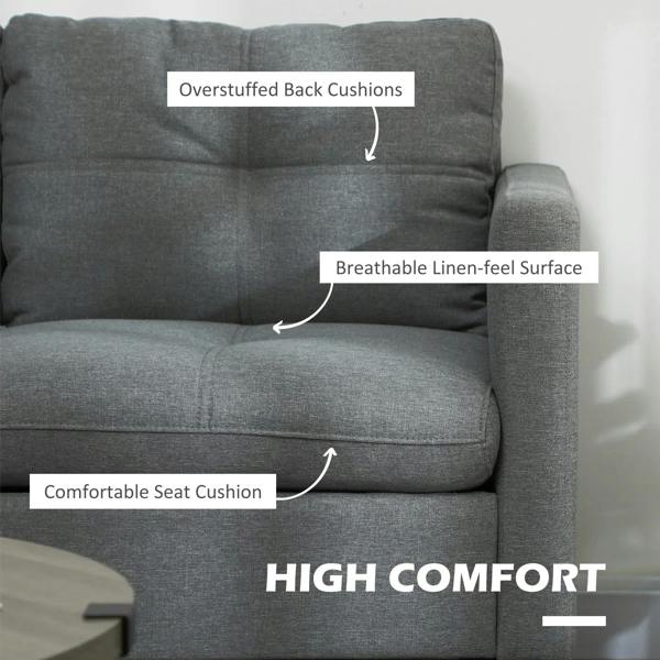 Dark grey upholstered sofa with overstuffed back cushions and a comfortable seat cushion