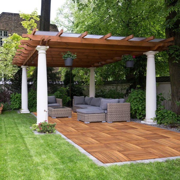 Wooden decking tiles in a herringbone pattern, rich brown color, enhancing a stylish outdoor patio under a pergola with seating
