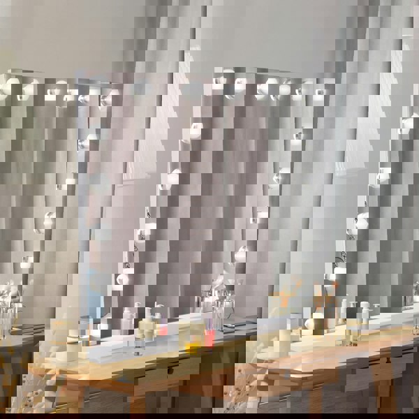 LED Bluetooth mirror, 80 x 60cm, features bright round bulbs, sleek white frame, and a stylish vanity setup with skincare products