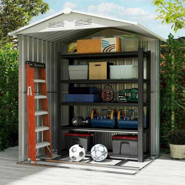Green metal shed interior with sliding door open and storage shelves