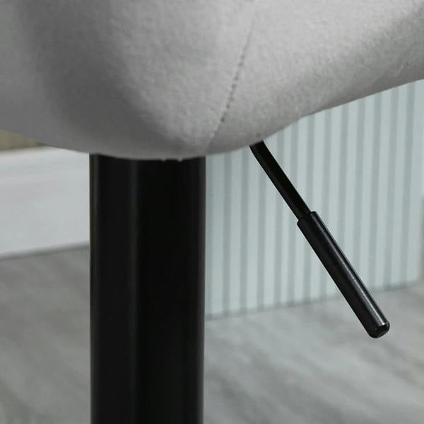 Grey velvet bar stool arm and black support column with visible height-adjust handle
