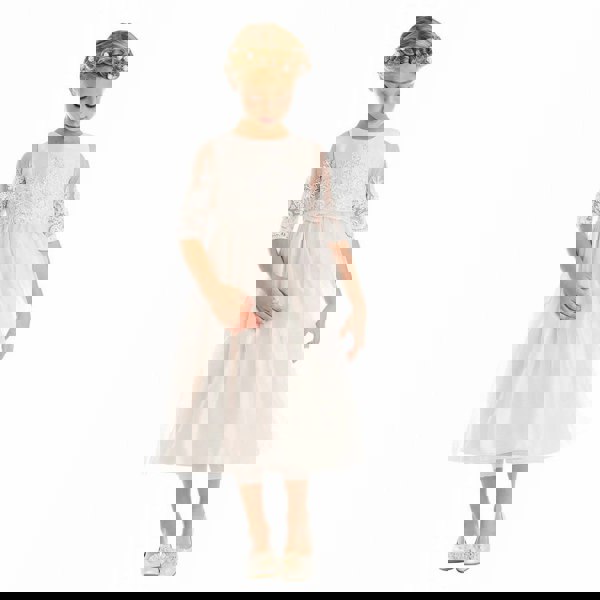 Girl wearing white flower girl dress