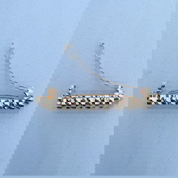 Gold barrette hair clasp, polished metallic finish, twisted bar design, strong clasp fastening, sleek minimalist style, decorative hair accessory
