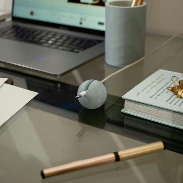 Desk setup with laptop, mug, notebook with our decorative cable clip
