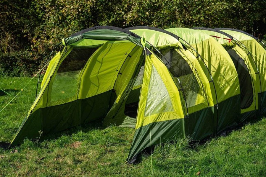 An image of the Abberley XL Extension by Olpro attached to the Abberley XL Tunnel Tent on a camping field.