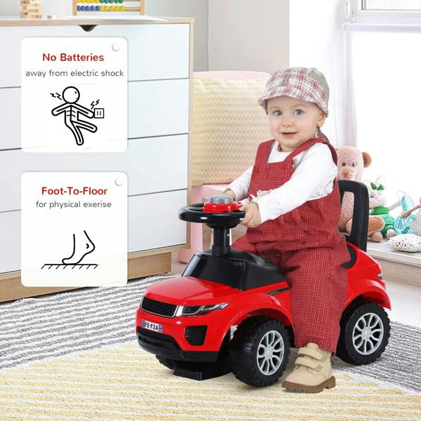 Red foot-to-floor ride-on car with black steering wheel and dashboard; toddler seated inside