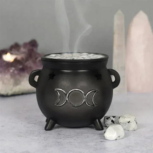Black cauldron incense cone holder with moon emblem, side handles, incense smoke