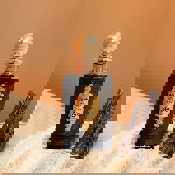 Sapil Royale Oud bottle on sand with oud wood pieces