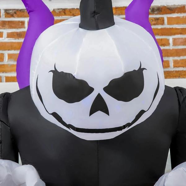 Black inflatable ghost with purple horns and large jack-o’-lantern face, blue-lit