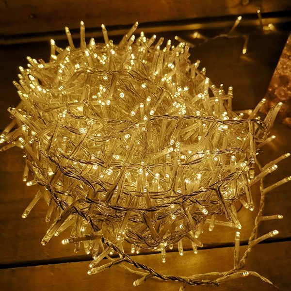 Samuel Alexander 1000 LED 25m Indoor Outdoor Christmas Multi Function Mains Operated String Lights with Timer & Clear Cable in Warm White