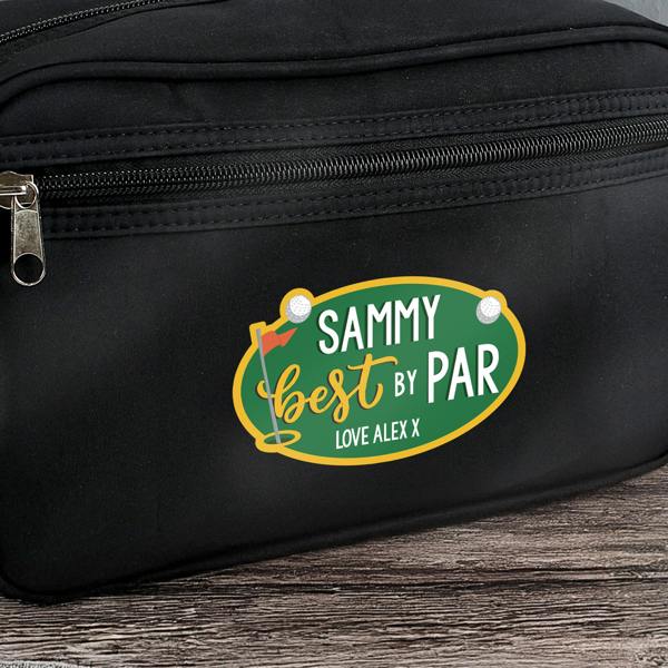 A close-up detail shot of a black canvas wash bag showing a green oval golf badge printed with 'Sammy Best By Par Love Alex X'.
