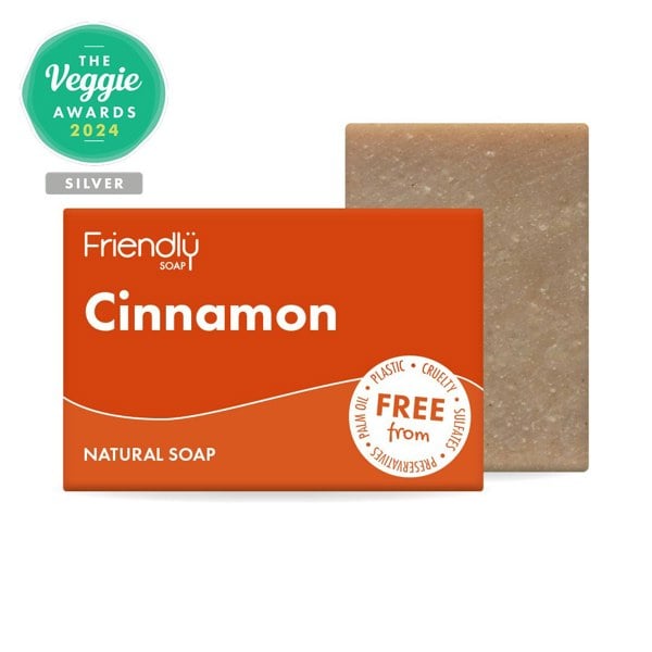 Cinnamon soap bar with packaging on white background