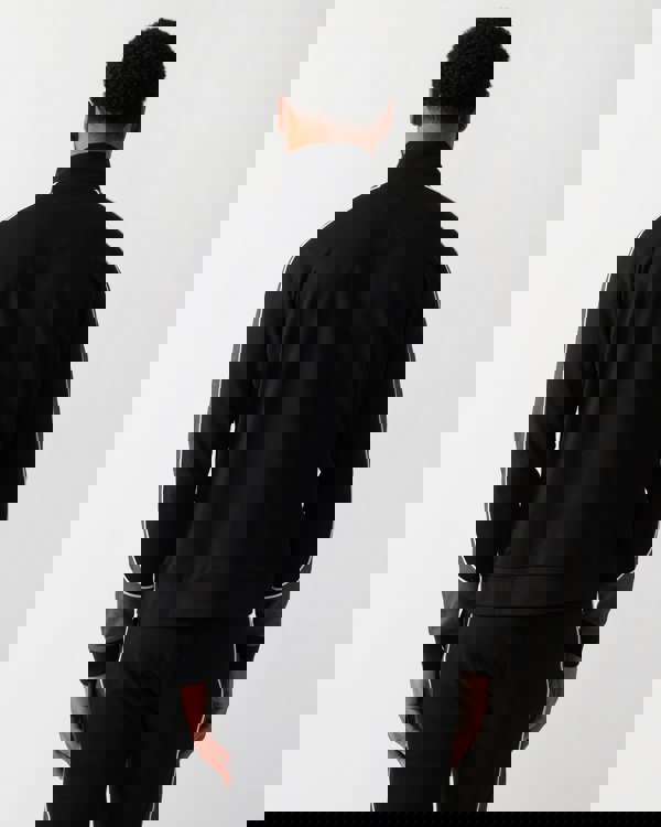 Back shot of a Model wearing a BOSS Orange Mens 1/4 Zip Loungewear Tracksuit Jacket in Black