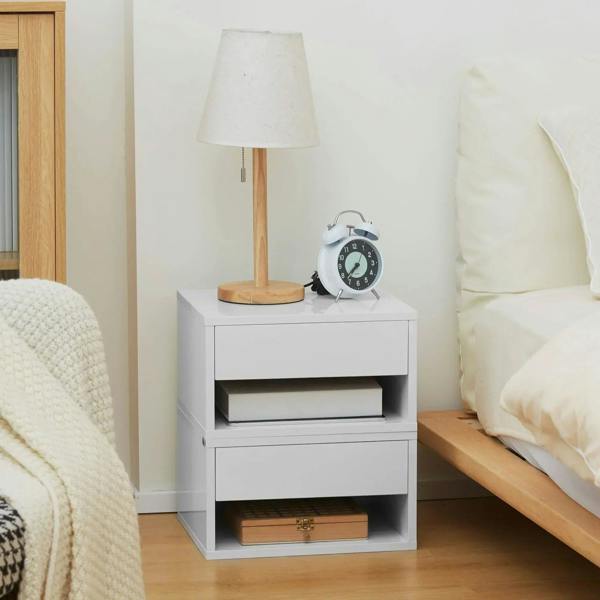 White floating bedside table with drawer and open shelf compartments, topped with lamp