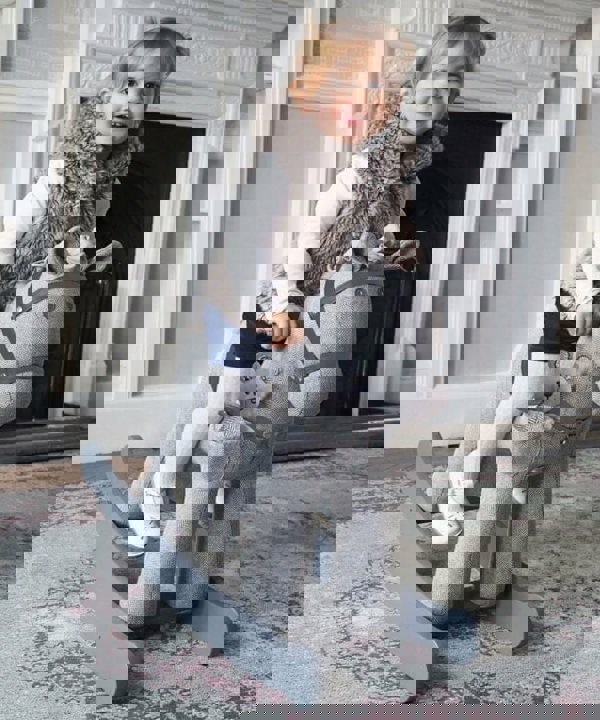 Girl rocking on a Stirling & Mac Rocking Horse in front of fireplace