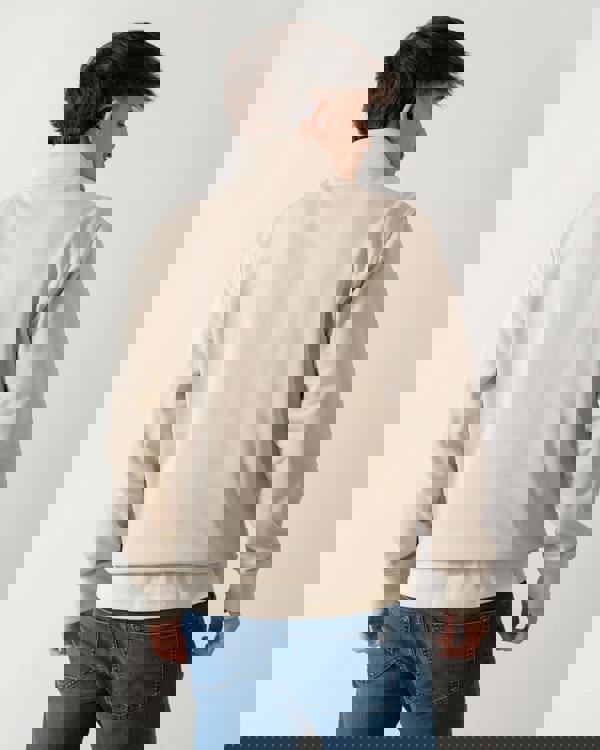 back shot of a model wearing a Moose Knuckles Hartsfield Mens 1/4 Zip Sweatshirt in Alabaster 1705