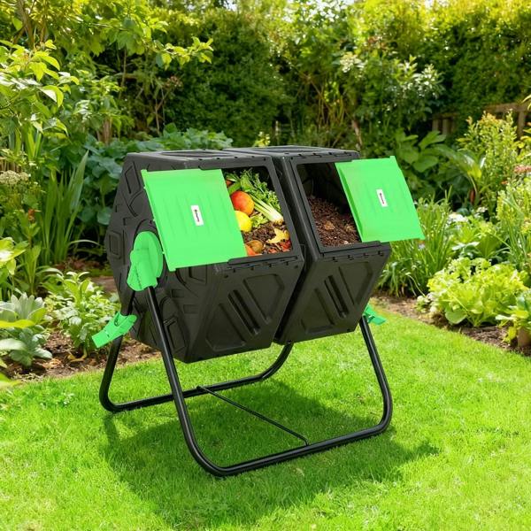 Black dual-chamber compost tumbler with green lids open, filled with garden scraps on legs