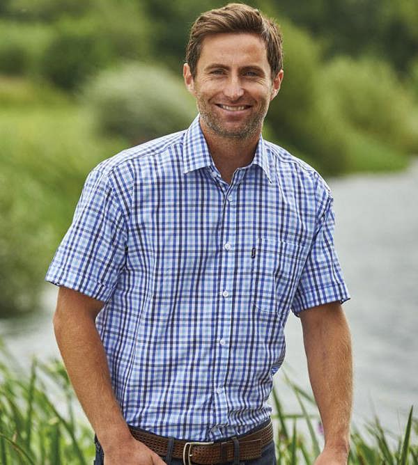 Man outside wearing Champion Doncaster light blue check shirt – ideal for warm country days