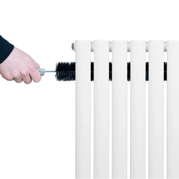 White oval single column radiator being cleaned with a brush, showcasing its smooth surface and sleek design, ideal for modern interiors