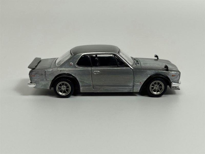a silver toy car on a white background