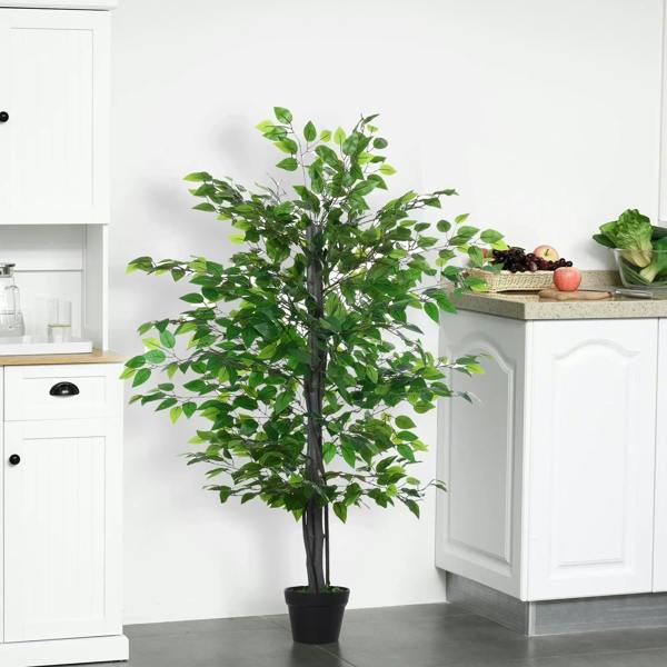 Artificial potted leafy tree with green foliage placed on indoor floor