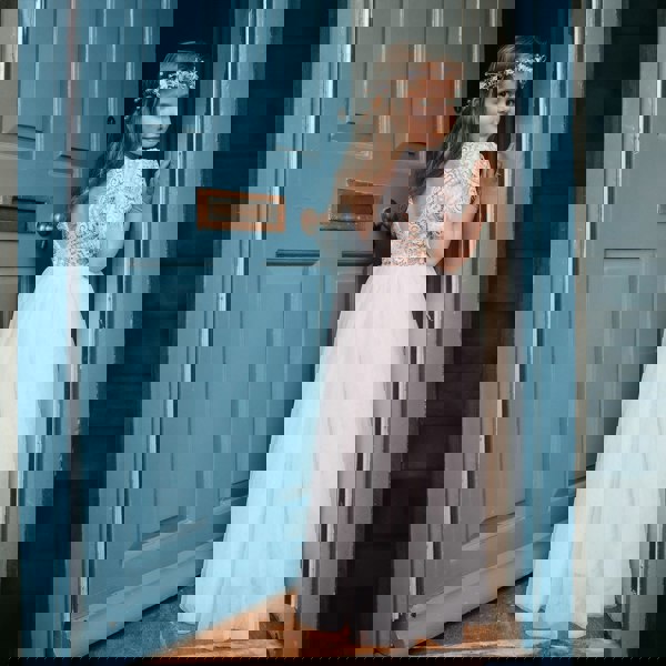 Floor Girl wearing a lace back Flutter Dress in Ivory