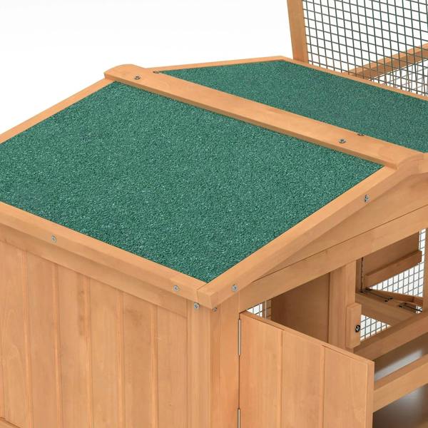 Close-up of green roof panel on wooden two-tier hutch with corner screws and mesh