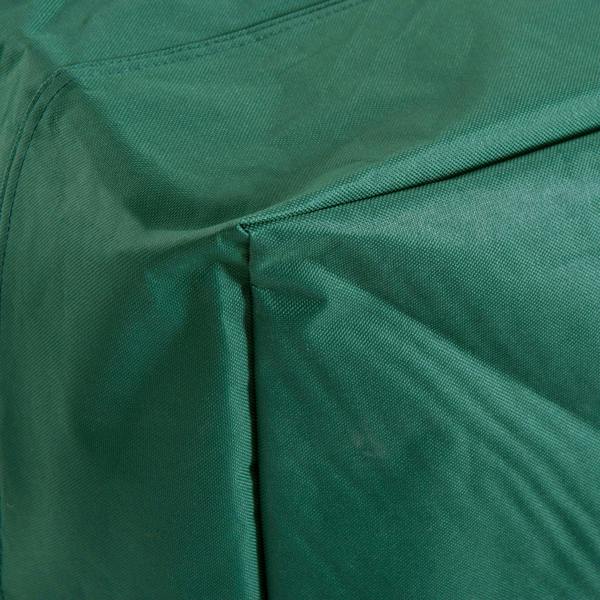 Green patio furniture cover close-up showing stitched panel seams and edges