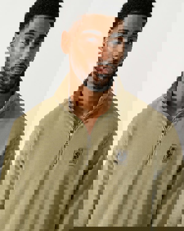 Detail shot of a Model wearing a Belstaff Quarter Zip Sweatshirt in Fatigue Green