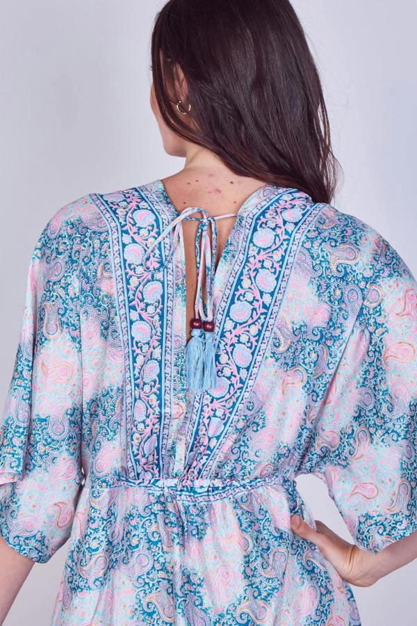 Woman wearing a floral dress with a plain background