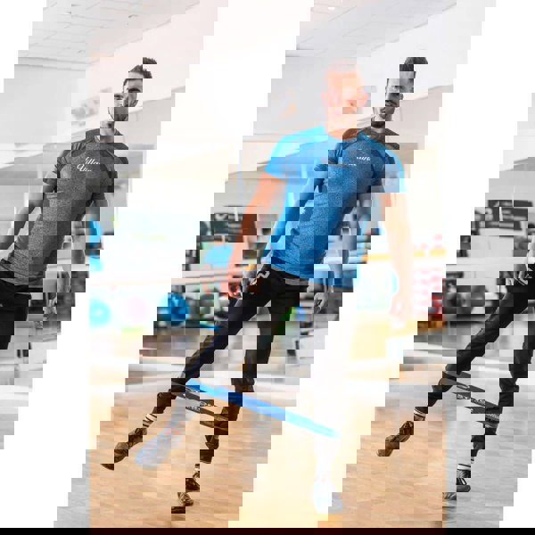 Man exercising with Fitness Mad Mini Loop Strong around his calves