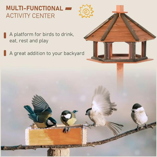 Wooden bird feeding station with slanted roof and open trays on tall post