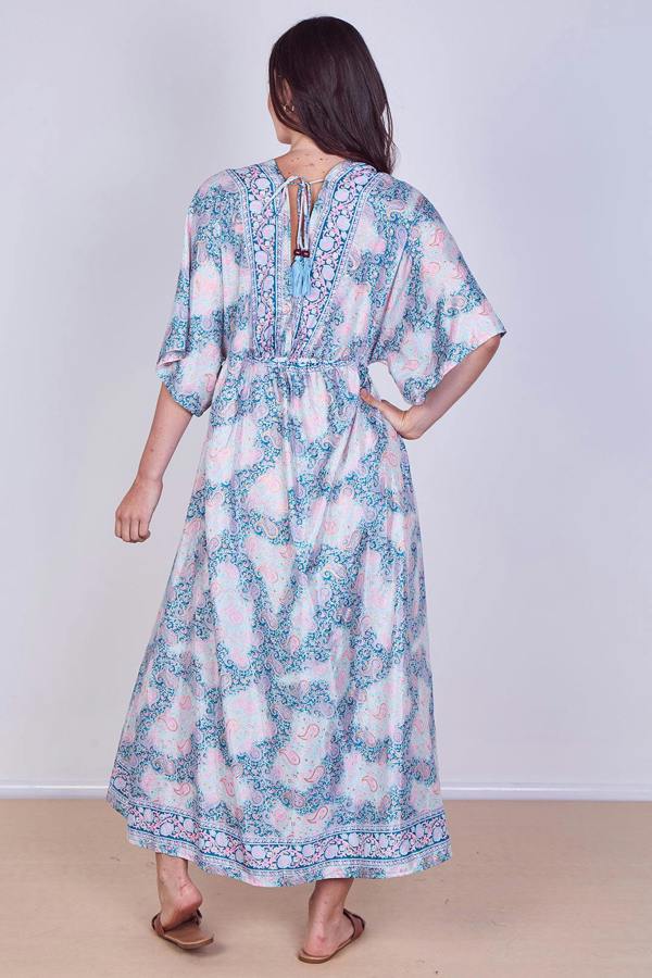 Woman wearing a floral dress with a plain background